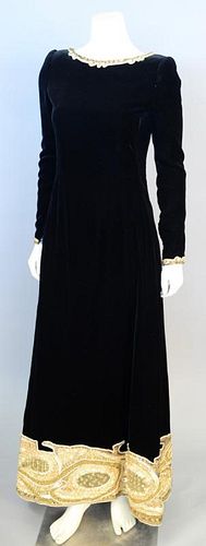 Mary McFadden, c. 2000, Evening dress of black velvet, straight cut, with broad band of gold embroidery with sequins and gold beads around hem. Zipper