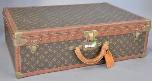 Louis Vuitton vintage suitcase or trunk having brown monogram canvas with leather trim and handle.