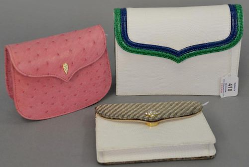 Three Lana of London handbags including pink ostrich skin bag (never used), a snake skin purse, and a white snake skin clutch purse.