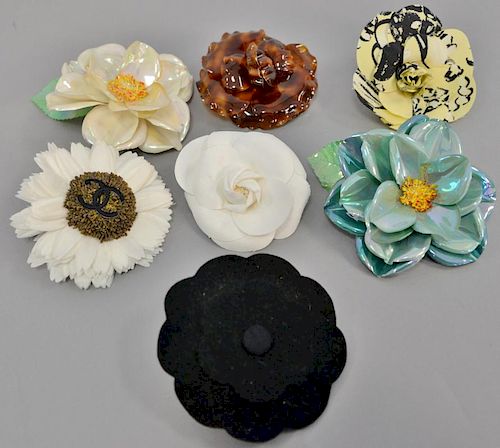 Seven Chanel Camelia Rose flower corsage/pin/brooches, three plastic, three cloth, and one felt.