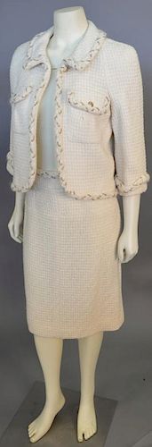 Chanel two piece suit, ivory with gold chain accents throughout rope trim including waist length jacket and matching skirt.