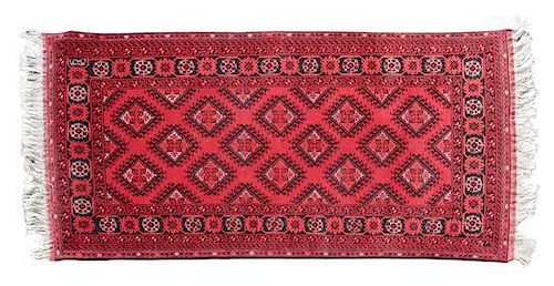 A Turkoman Wool Rug 6 feet 8 inches x 3 feet 3 1/2 inches.