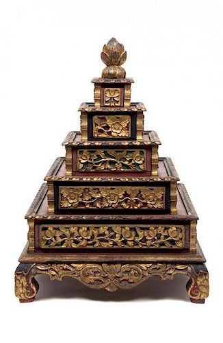 An Indonesian Parcel Gilt Red Lacquer Five-Tiered Bride's Box Height 20 x width 15 x depth 15 inches.