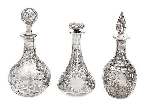 * A Group of Three Silver Overlay Glass Bottles Height of tallest 7 1/2 inches.