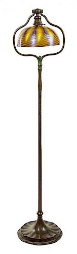 * A Tiffany Favrile Glass and Bronze Floor Lamp Height 55 1/2 x diameter of shade 10 inches.
