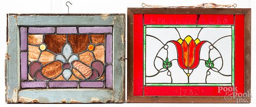 Three small stained glass windows, with another