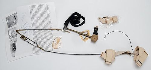 Kepplinger Holdout Device. American, unmarked, ca. 1960. Brass and steel with reinforced flexible tubing. With a page of instructions, photographicall