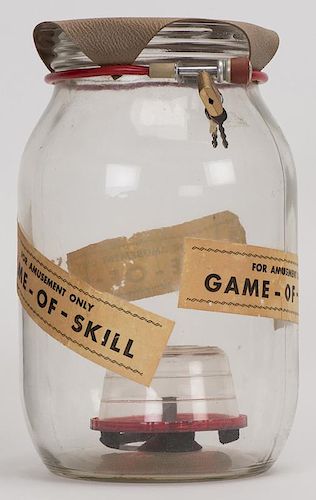 Wishing Well. Players attempt to land a coin on the small platform within the large glass jar after it has been filled with water. Labeled on the side