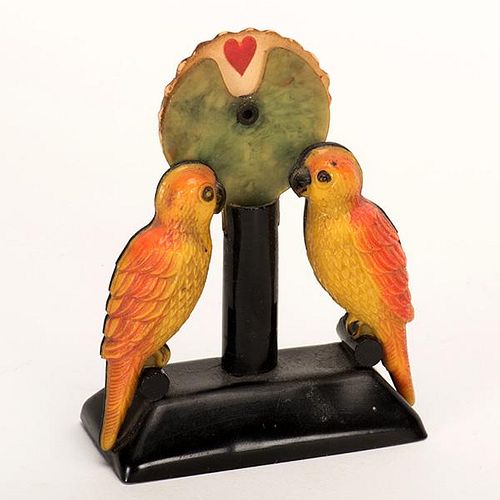 Parrot Trump Indicator. Circa 1930. Celluloid parrots with paper wheel showing suit signs. Excellent.