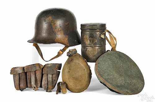 German WWI military accessories and gear, to include a camouflage helmet with pencil inscription