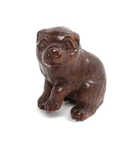 A Small Japanese Carved Wood Netsuke Height 1 1/2 inches.