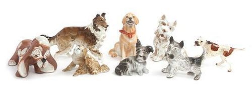 Eight Porcelain Dogs Width of widest 6 1/2 inches.