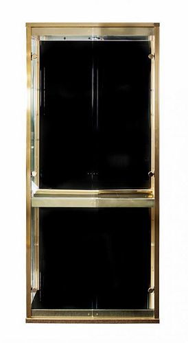 A Brass and Glass Vitrine Height 74 1/4 x width 33 x depth 13 1/2 inches.