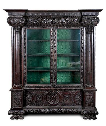 * A Continental Carved Oak Display Cabinet Height 86 1/4 x width 70 x depth 25 1/2 inches.