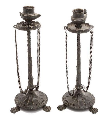 * A Pair of Neoclassical Cast Metal Candlesticks Height 9 3/4 inches.