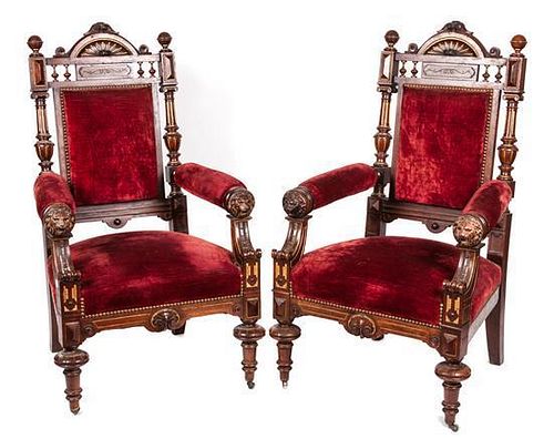* A Pair of Victorian Ebonized Carved and Parcel Gilt Open Armchairs Height 46 inches.