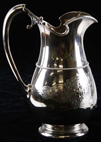 Gorham Mfg Co (1864-69) sterling silver water pitcher with circular foot. Baluster form with helmet