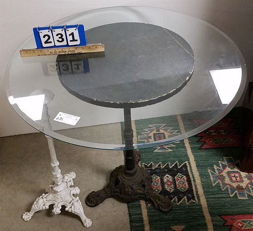 CAST IRON BASE GLASS TOP TABLE AND 31 1/2"H X 33" DIAM AND SM CAST IRON BASE 26"H