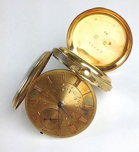 Antique 18k yellow gold pocket watch having face engraved with Roman numeral indicators and foliate,
