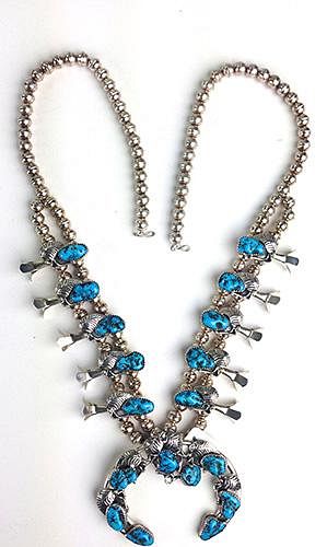 20th c sterling Navajo squash blossom necklace. 10 blossoms each with foliate and turquoise type des