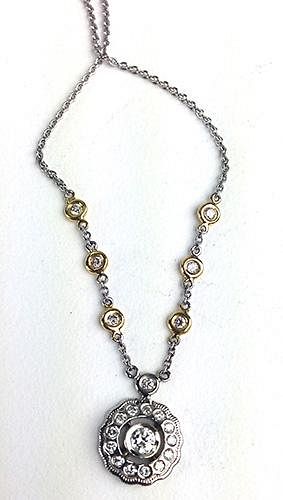 18k w.g. diamond pendant and chain. Pendant having center brilliant round cut diamond .15ct with 14