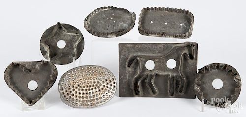 Seven tinned sheet iron cookie cutters, 19th c., to include a horse, a heart, a star, etc.