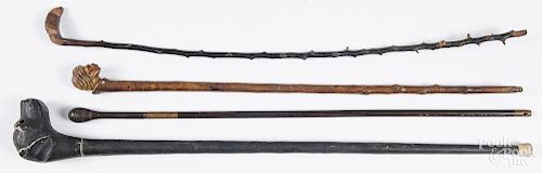 Four carved walking sticks, early/mid 20th c.