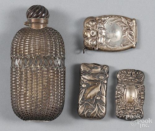 Three sterling silver vesta match safes, together with a silver wrapped flask.