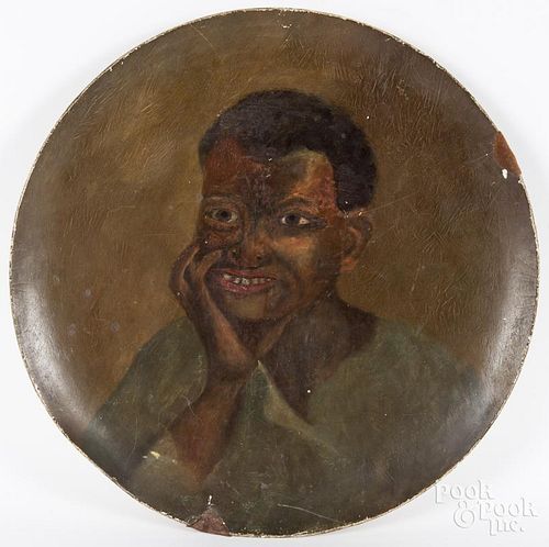 Large painted pâpiér-mache charger with a portrait of an African American boy, 21 3/4'' dia.