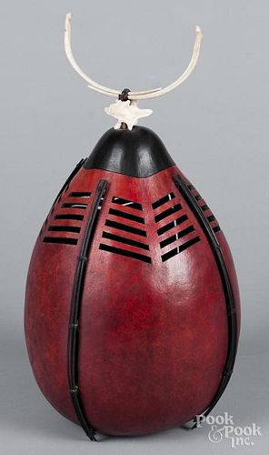 Bone and tropical seed pod urn, 17" h., together with a painted wood hanging sculpture