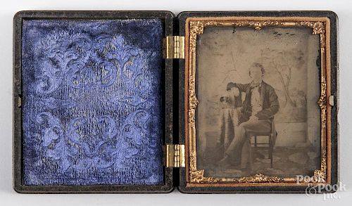 Ambrotype image of a young man and his camera, 19th c., sixth plate, in a Union case.