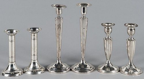 Three pairs of weighted sterling silver candlesticks, tallest - 9''.