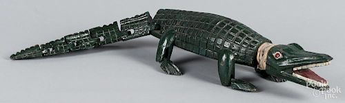 Carved and painted alligator with an articulated tail and feet, 28'' l.