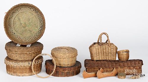 Eight Native American Indian baskets, early 20th c., together with two bark canoes, a needle case