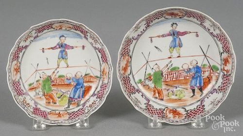 Two Chinese export porcelain mandarin palette acrobats saucers, late 18th c., 4 78'' dia.