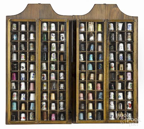 Thimbles mounted in two hanging display cases, 16'' x 9''.