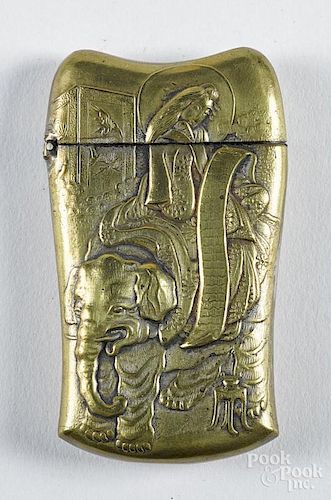 Embossed brass match vesta safe, ca. 1900, with a scene of a geisha holding a scroll