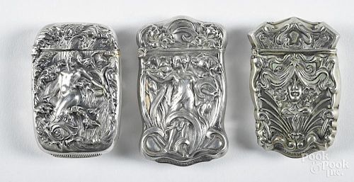 Three heavily embossed silveroin match vesta safes, ca. 1900, to include one of a nude woman