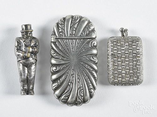 Three match vesta safes, ca. 1900, to include one of a figural gentleman in a top hat, 2 1/8'' h.