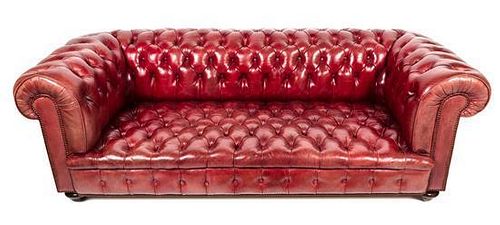 A Red Leather Upholstered Chesterfield Sofa Height 42 x width 84 x depth 36 inches.