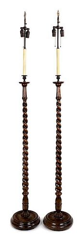 A Pair of Georgian Style Oak Standing Lamps Height 54 inches.