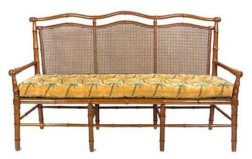 A Faux Bamboo and Caned Settee Height 40 x width 67 x depth 19 inches.