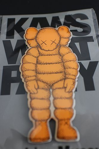 KAWS (American, b.1974) "What Party?" orange magnet, brand new, 4 x 2 in. 