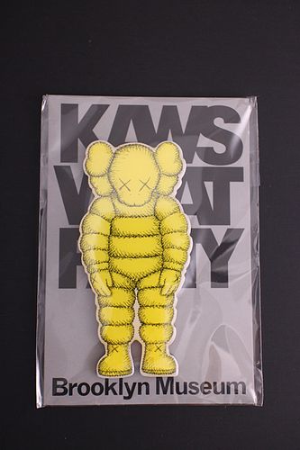KAWS (American, b.1974) "What Party?" yellow magnet, brand new, 4 x 2 in. 