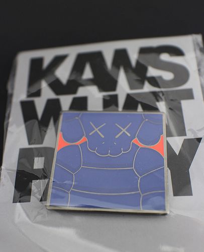 KAWS (American, b.1974) "What Party?" blue and red pin, never opened, 1 1/2 x 1 1/2 in.