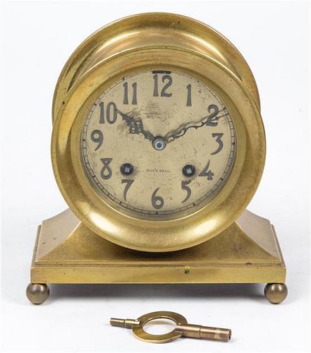 * A Brass Chelsea Ship's Bell Clock Height 7 inches.
