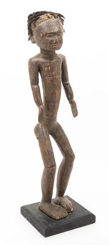 * A Carved Ethnographic Figure Height 23 inches.
