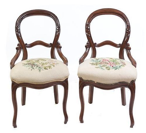 A Pair of Victorian Walnut Balloon Back Chairs Height 35 1/2 inches.