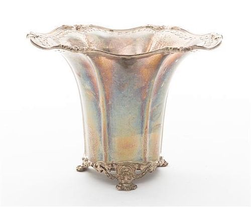 * A Silver Footed Vase, , having an undulating rim with floral and pierced decoration.