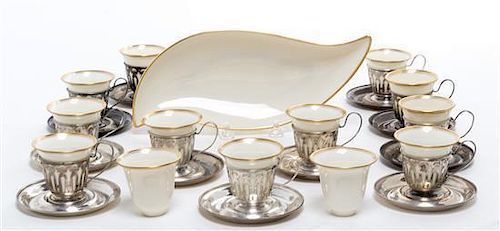 A Set of Twelve Silver Demitasse Cups and Saucers, , each cup with pierced decoration and Lenox porcelain liner, the saucers eng